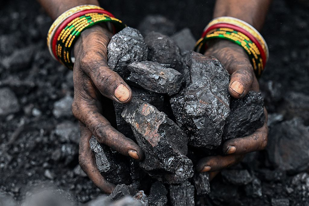 Coal miner working at an open-pit mine on the outskirts of Dhanbad, India. VCG
