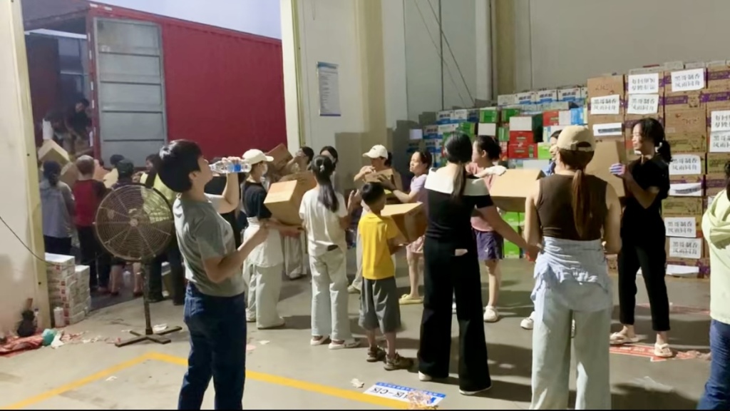 Men, women, old and young form a 'human chain' to pass along supplies