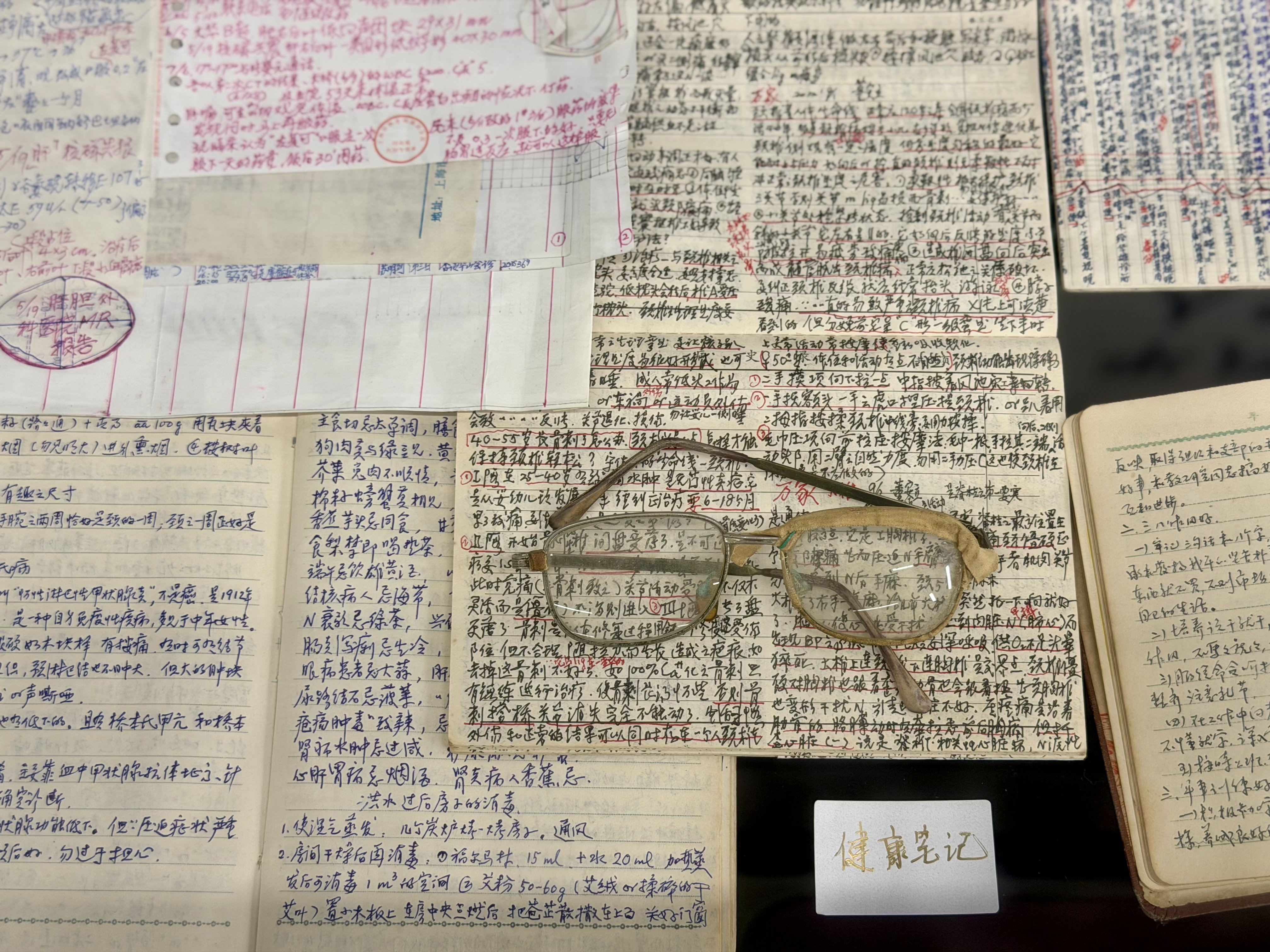 Taped-up old glasses and densely written notes.