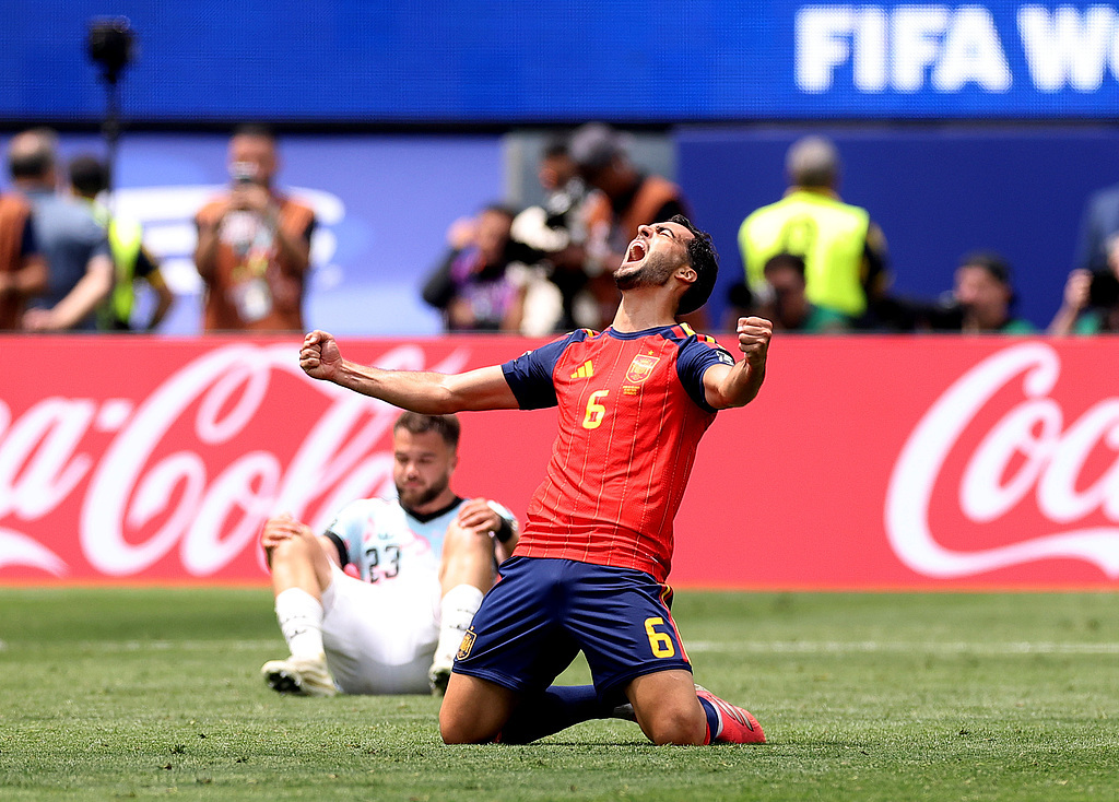 Spain’s Merino celebrates his late winner against Belgium