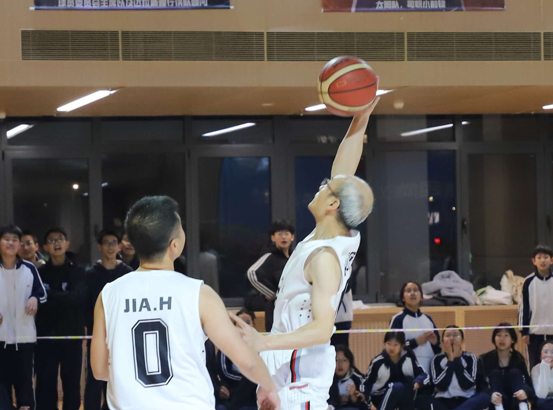 Huang Chun playing ball (right).